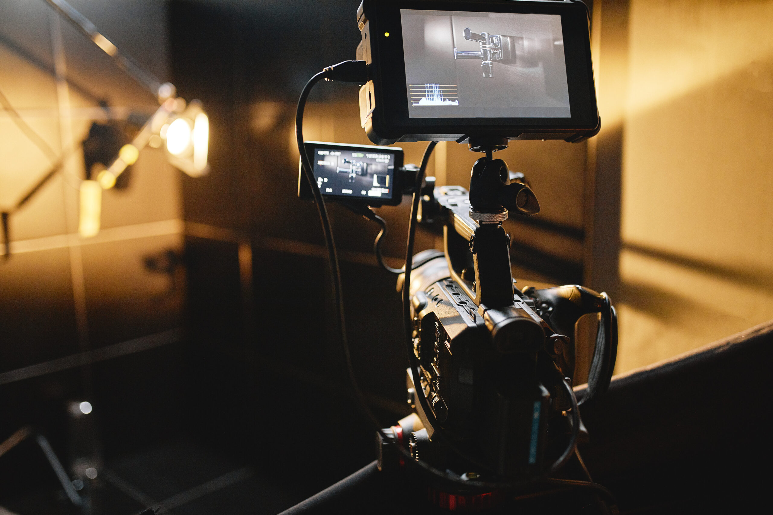 Video production backstage. Behind the scenes of creating video content, a professional team of cameramen with a director filming commercial ads. Video content creation, video creation industry. Low key, selective focus, film graine sedona arizona